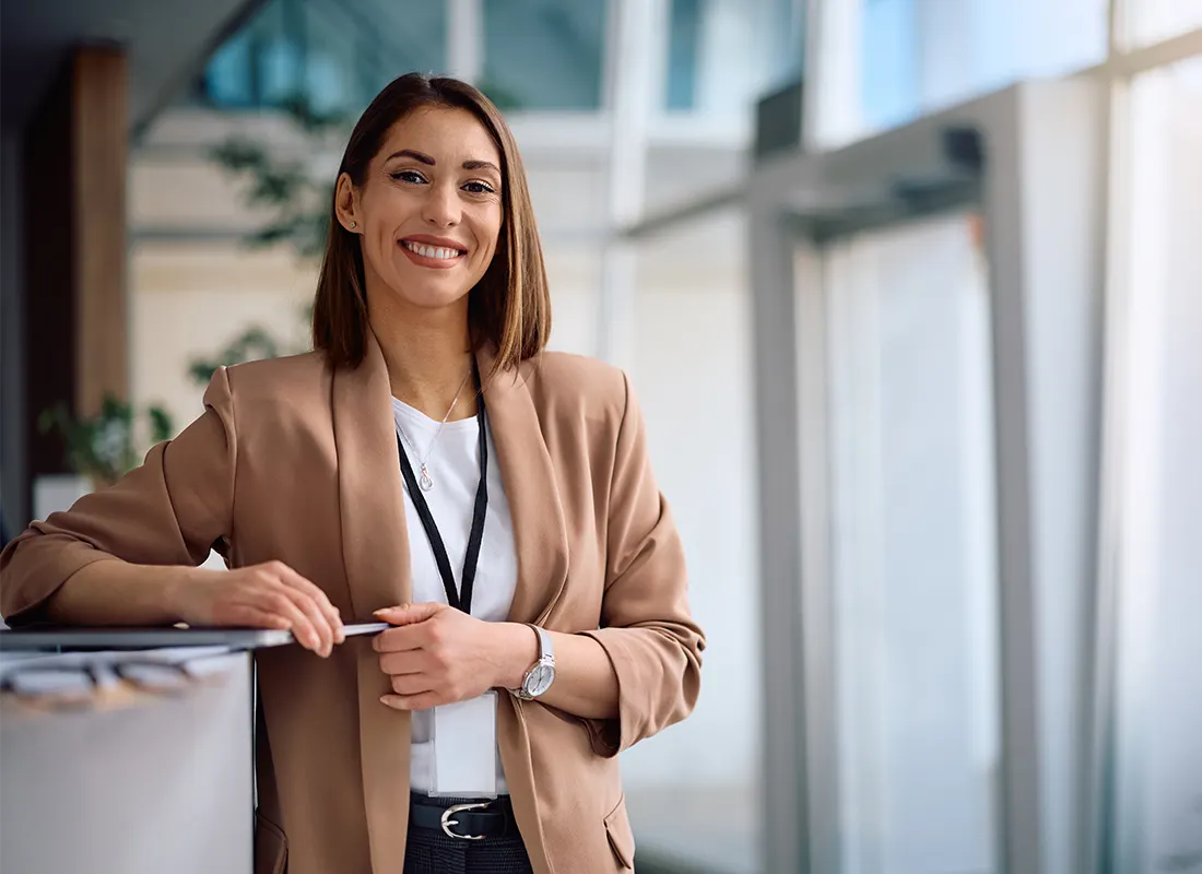 smiling-female-ceo-working-office-looking