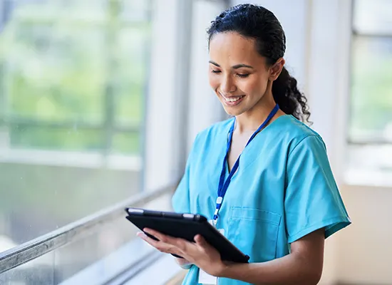 smiling-nurse-hospital-scrubs-using-digital