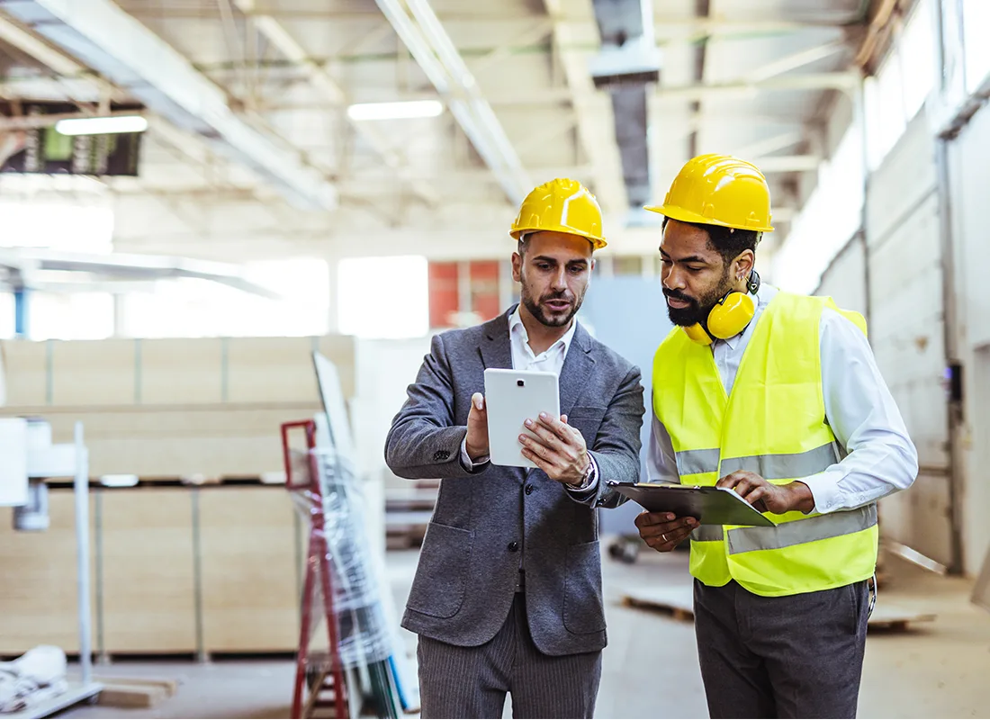 two-professionals-wearing-safety-gear-analyze