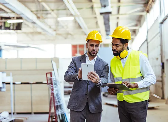 two-professionals-wearing-safety-gear-analyze